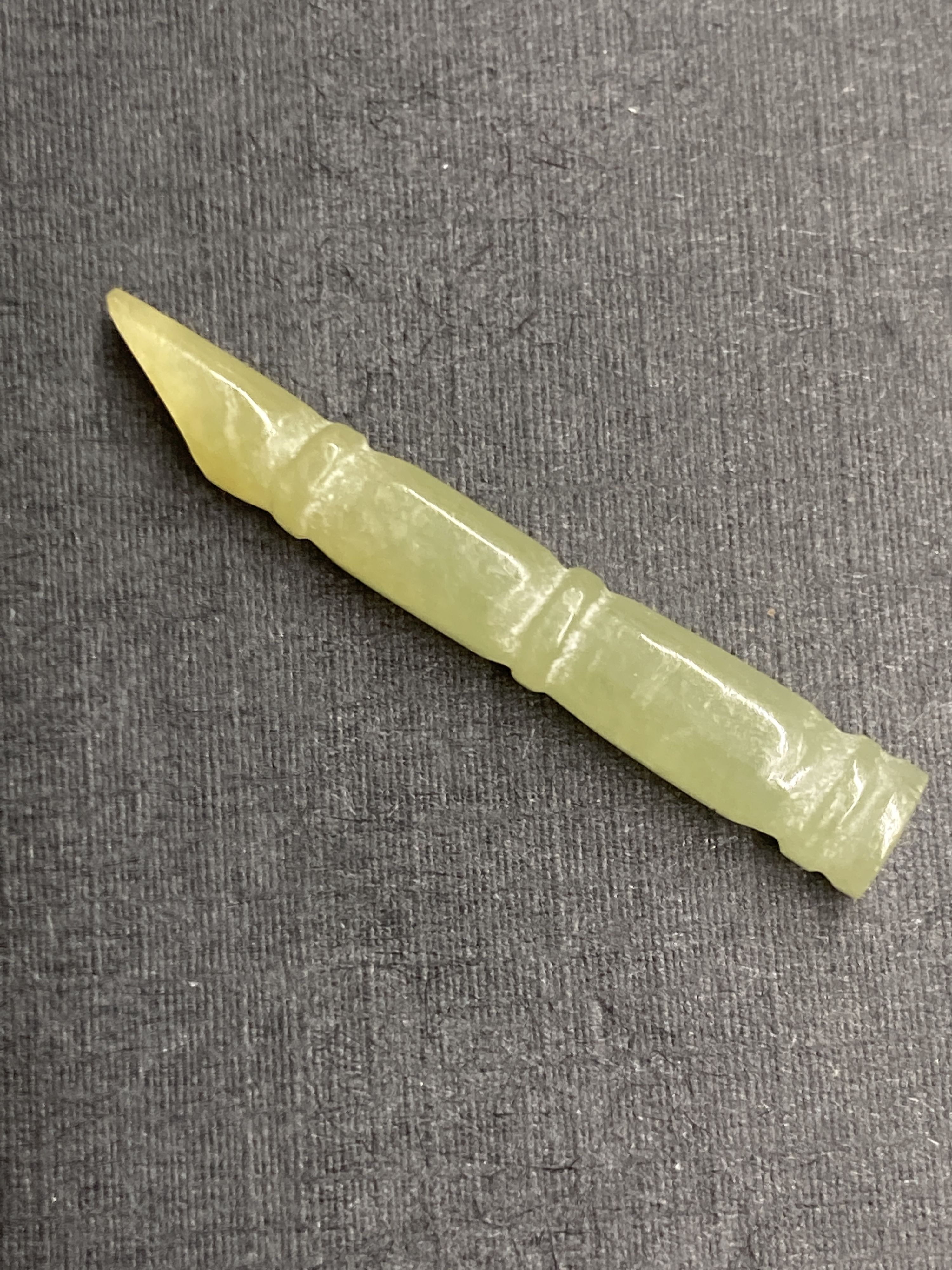 A Chinese jadeite gourd pendant, largest 43mm and two hardstone faux bamboo pendants.